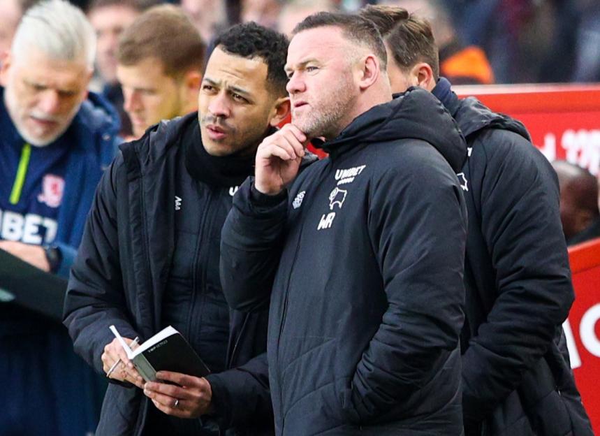 Derby County manager Wayne Rooney and assistant Liam Rosenior talk on the sideline.
