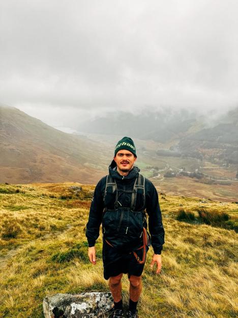 Matty from The Traitors standing outdoors in hiking gear.