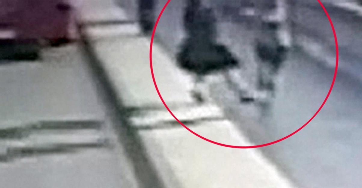 CCTV footage of a jogger pushing a woman into the path of a bus.