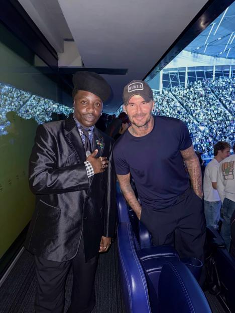David Beckham posing for a photo with Ramario Chevoy at a Jay-Z concert.