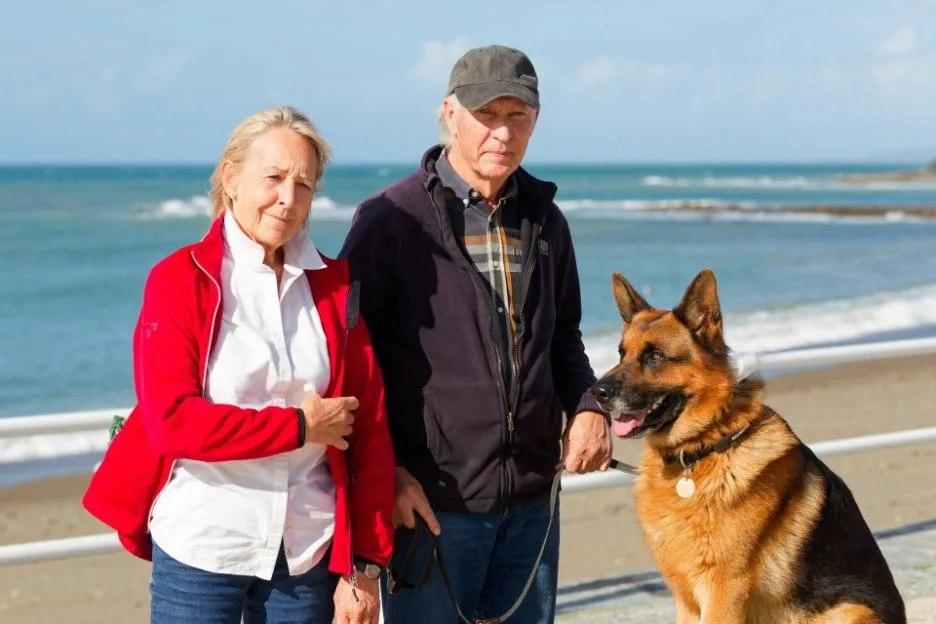 Jacqui, 74, and husband Paul, 76, with their German Shepherd dog Negan at Aberystwyth seafront.