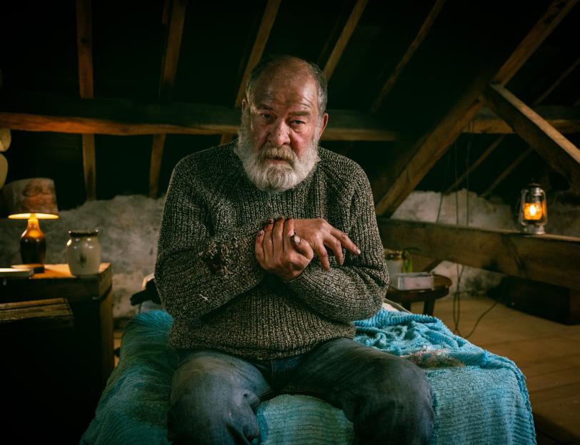 Joshua Richards as Bear Wolf in "Emmerdale," with blood on his hands and sweater.