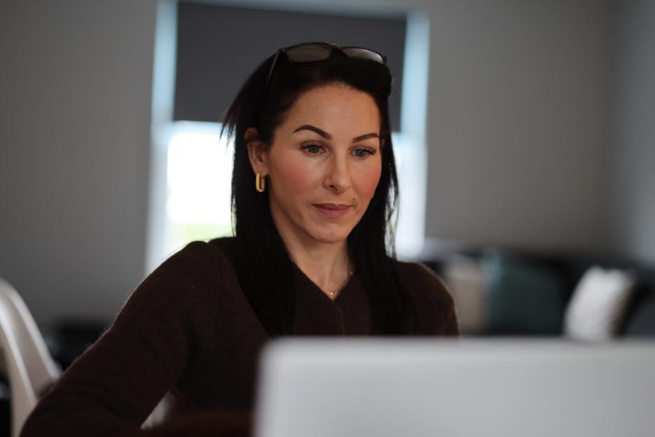 Hayley Stevens looking at a computer screen.