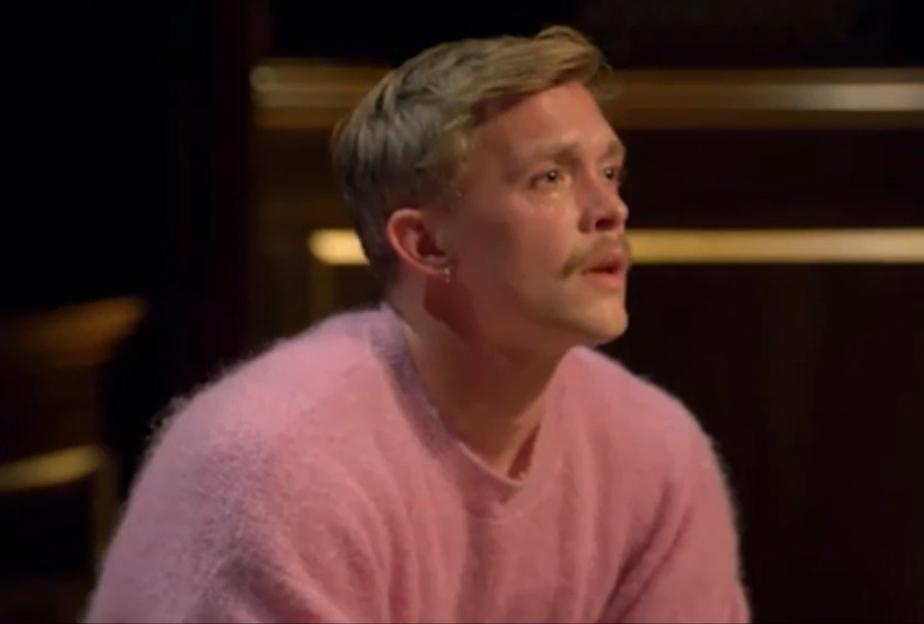 Stephen breaks down in tears while wearing a pink sweater.