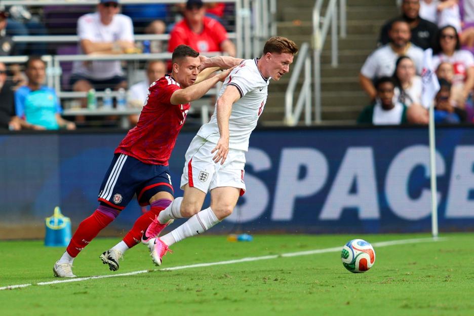 Elliot Anderson of England being challenged by a Costa Rica player during a FIFA World Cup match.