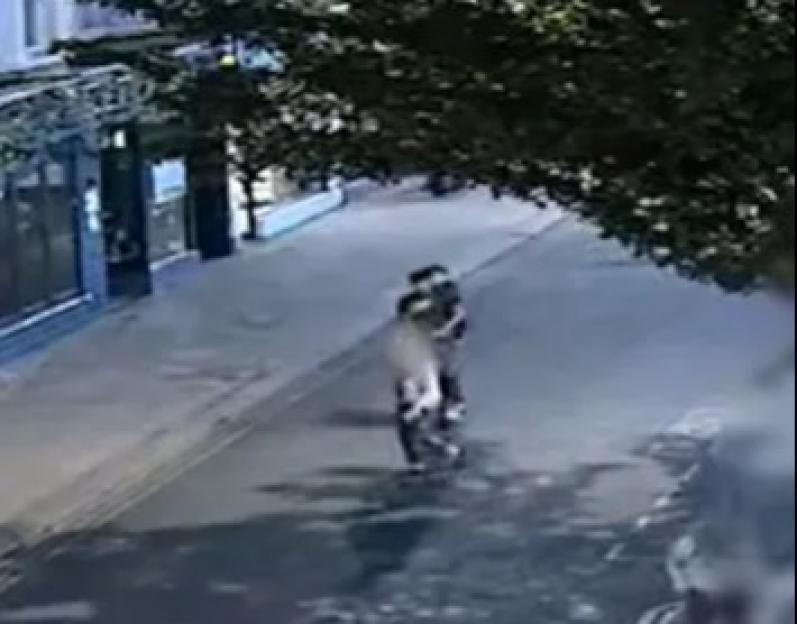 Horrifying moment 74-year-old woman is knocked down in road by two men on e-scooter hit & run as cops launch manhunt