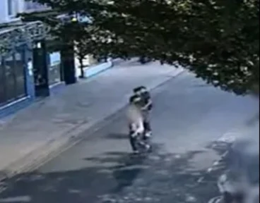 Horrifying moment 74-year-old woman is knocked down in road by two men on e-scooter hit & run as cops launch manhunt