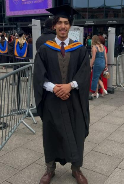 Cass, a young man, in a graduation cap and gown.