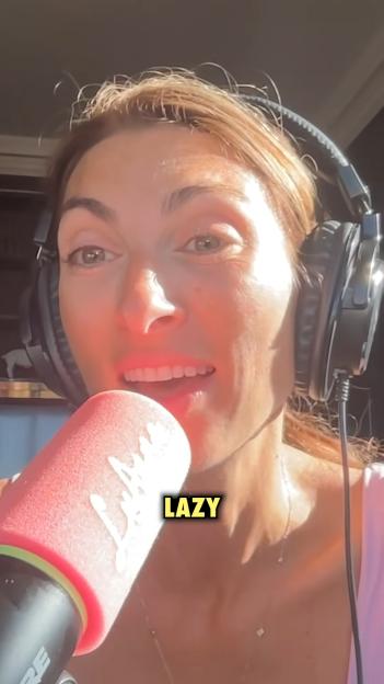 Luisa Zissman wearing headphones and speaking into a pink microphone with the word "LAZY" emblazoned on the screen.