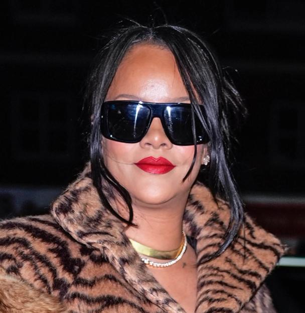 Rihanna in a full-length tiger-print coat and matching heels.