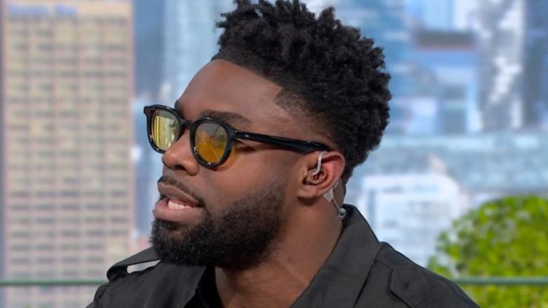 Close-up of Micah Richards speaking into a microphone.