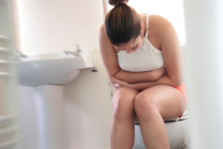 woman sitting on toilet