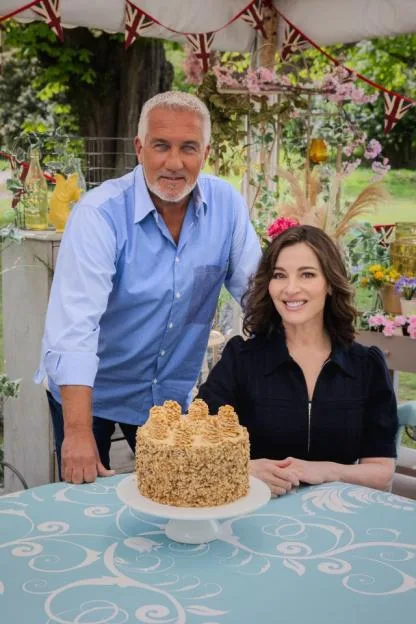 Paul Hollywood and Nigella Lawson with a cake from The Great British Bake Off.