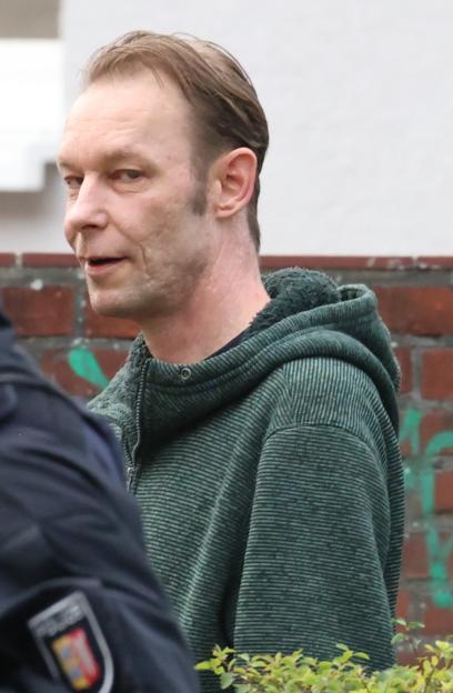 Christian Brueckner being led away by police from his home in Neumunster, Germany.