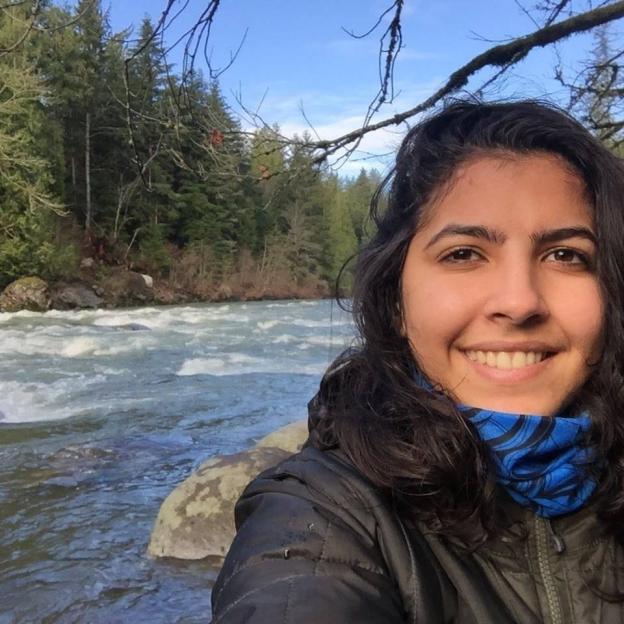 Vitoria Figueiredo Barreto smiling with a river and trees in the background.