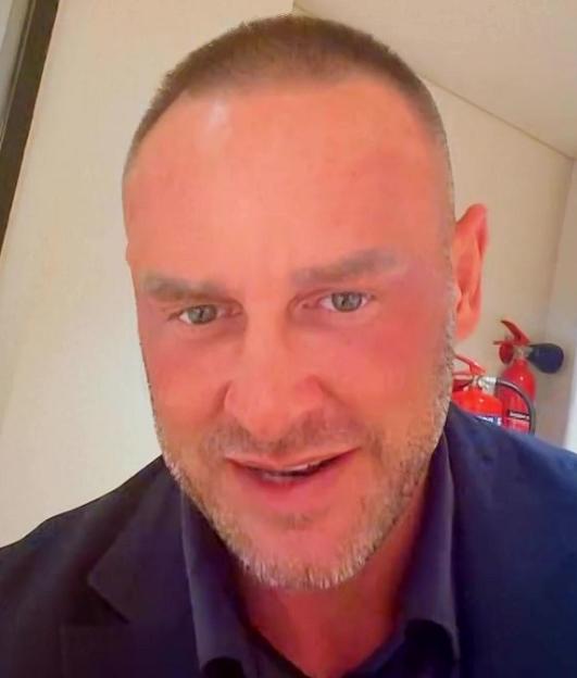 Close-up of Katie Price's husband, Lee Andrews, with fire extinguishers in the background.