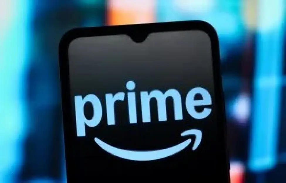 Photo illustration of the Amazon Prime logo on a phone screen.
