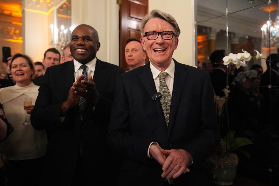 Foreign Secretary David Lammy (left) and British ambassador to the United States Peter Mandelson (right) laugh while clapping.