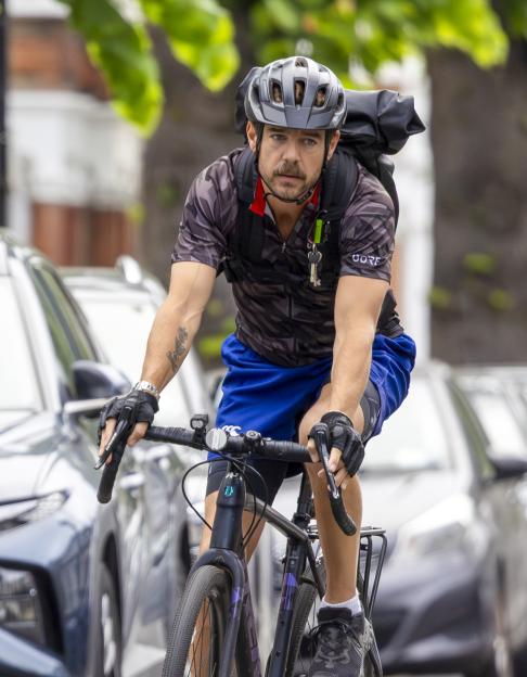 Nicholas Brandram, a suspect in the Putney Pusher case, riding a bicycle.