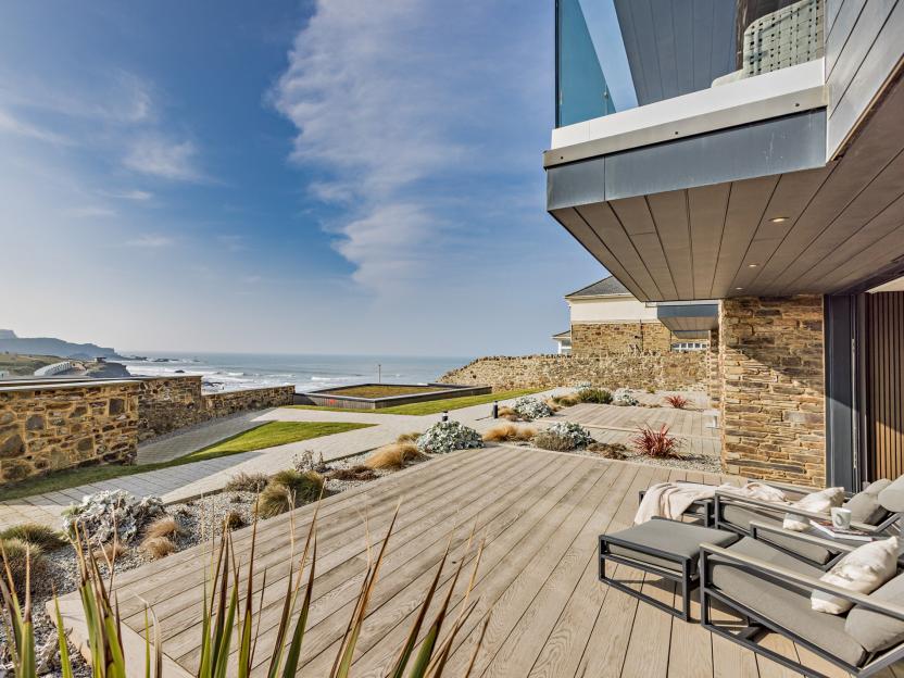 Seafront holiday home in Bude, Cornwall, with outdoor seating and ocean views.
