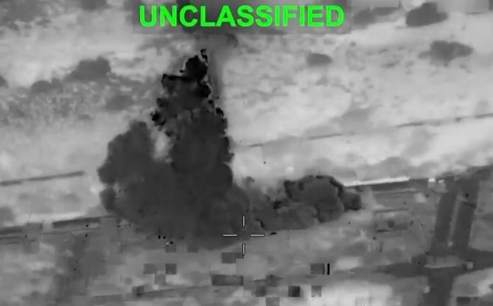 Thermal image showing an explosion on a landmass from an aerial perspective.