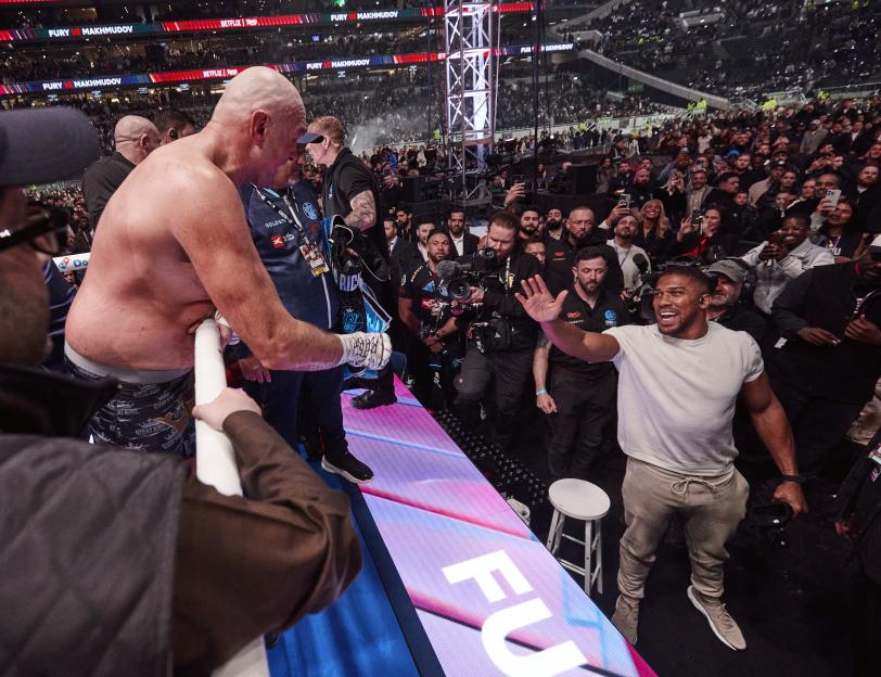 Tyson Fury exchanges words with Anthony Joshua at Tottenham Hotspur Stadium.