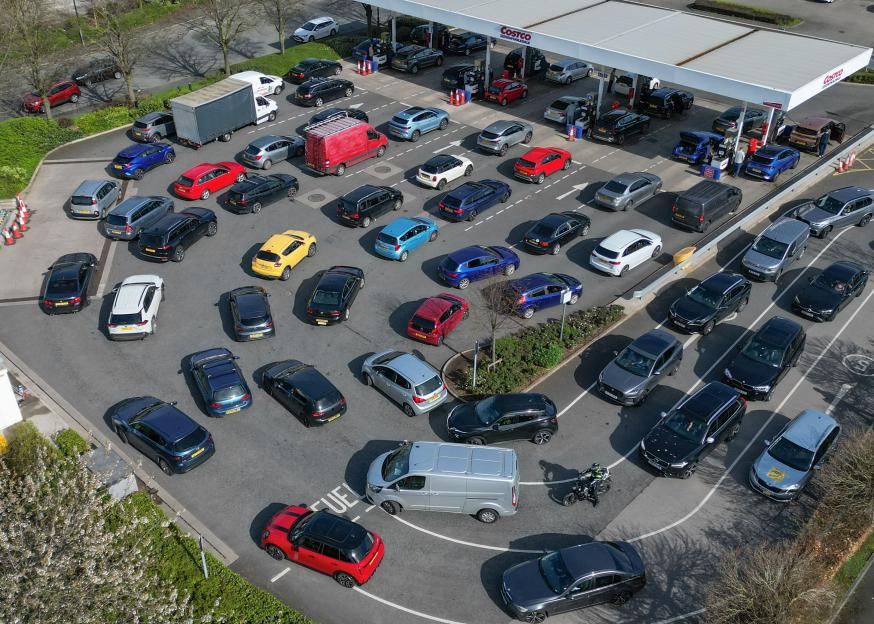 Aerial view of a Costco petrol station with cars queuing for fuel.