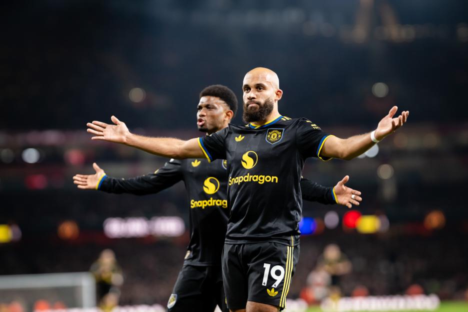 Manchester United's Bryan Mbeumo celebrates scoring a goal with teammate Amad.