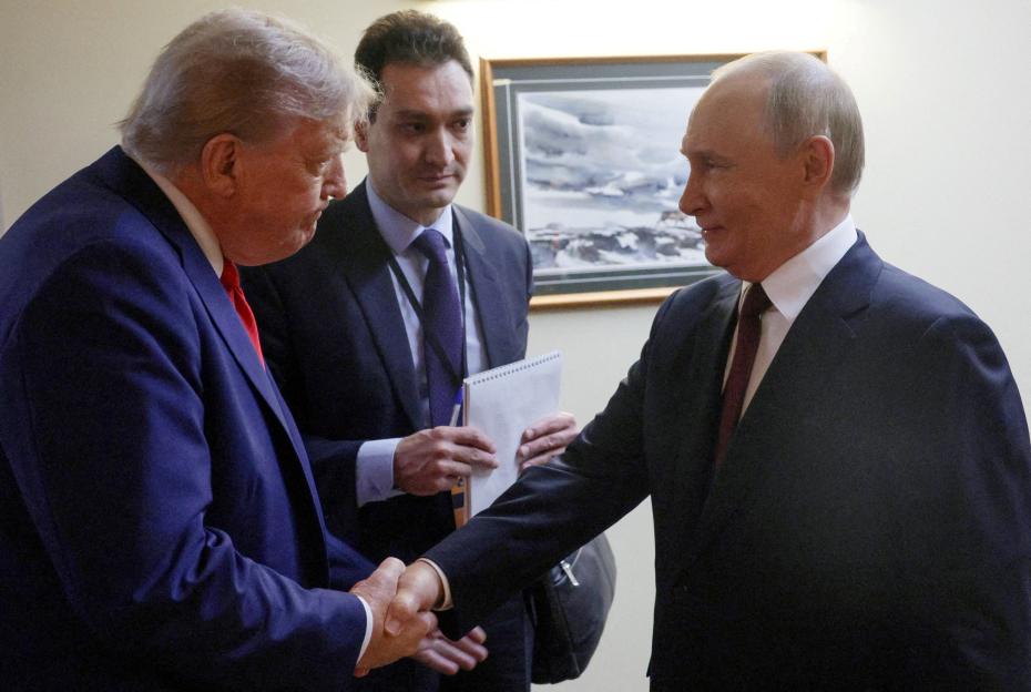 U.S. President Donald Trump shakes hands with Russian President Vladimir Putin.