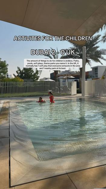 Two children playing in a shallow pool in Dubai.