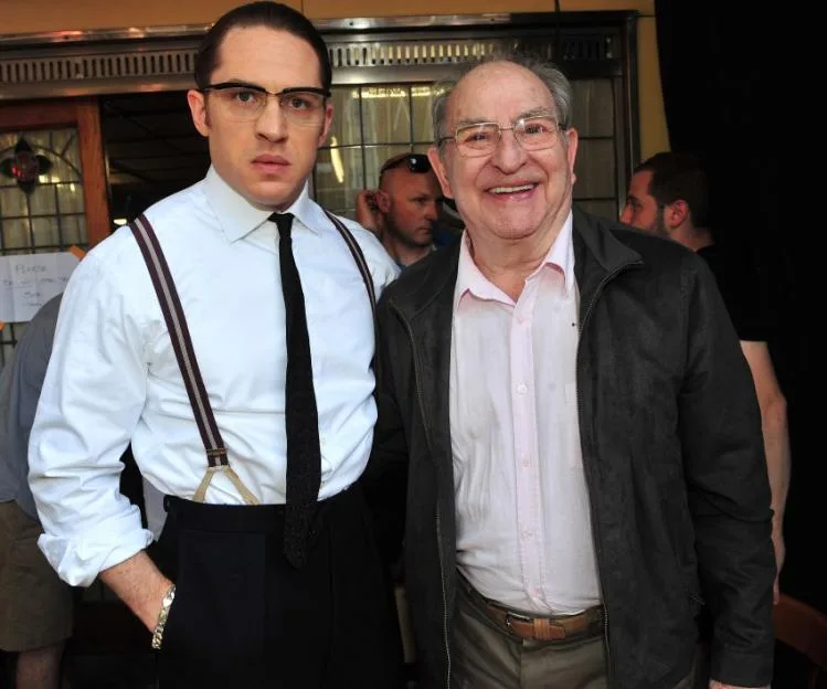 Actor Tom Hardy dressed in period costume as one of the Kray twins, standing alongside former gang member Freddie Foreman.