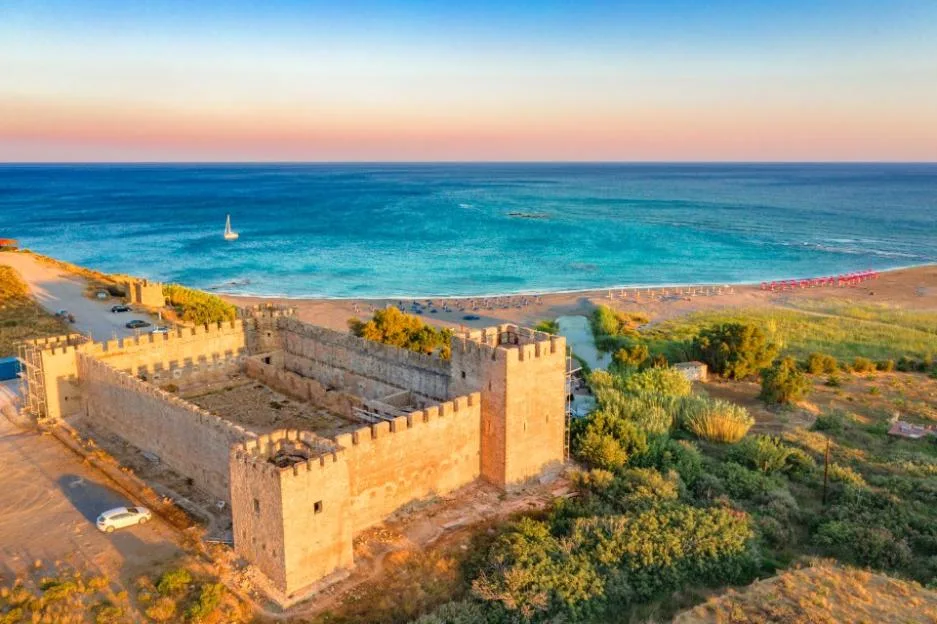 Aerial view of the medieval Venetian castle of Frangokastello situated next to a sandy beach and the blue sea in Crete, Greece.