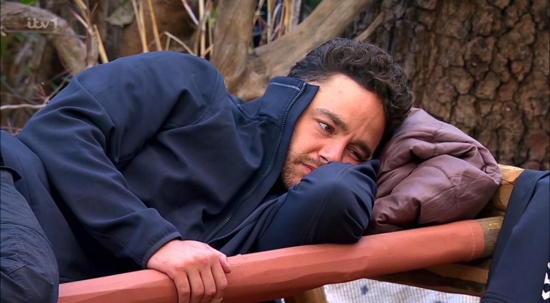 Adam Thomas looking serious while lying down.