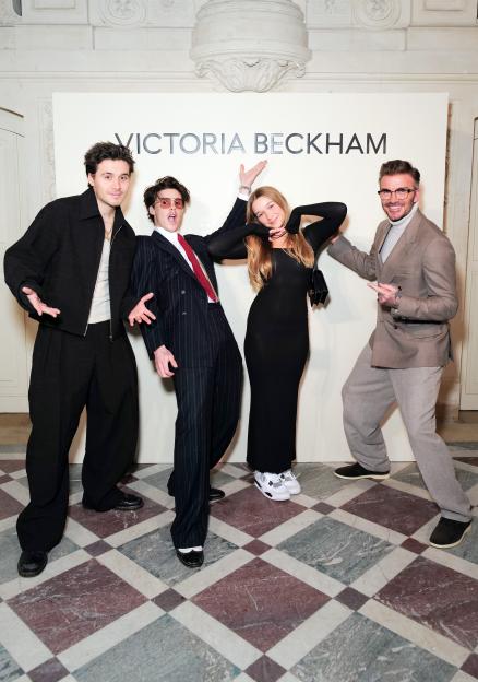 Brooklyn Beckham, Cruz Beckham, Harper Beckham, and David Beckham pose at the Victoria Beckham AW24 show.