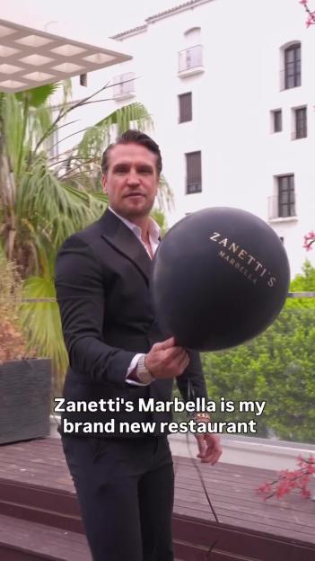Tom Zanetti holding a balloon advertising his new restaurant, Zanetti's Marbella.