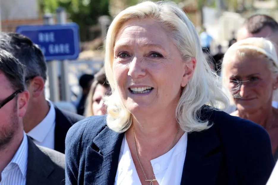 Marine Le Pen smiling at an event in Pomas, France.
