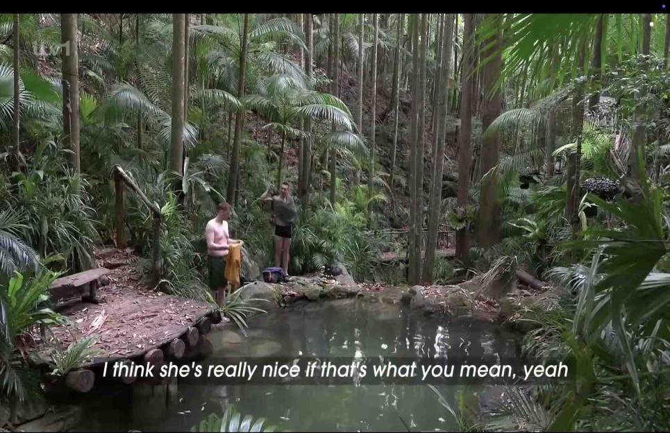 Ginge and Aitch by a lake in the jungle.