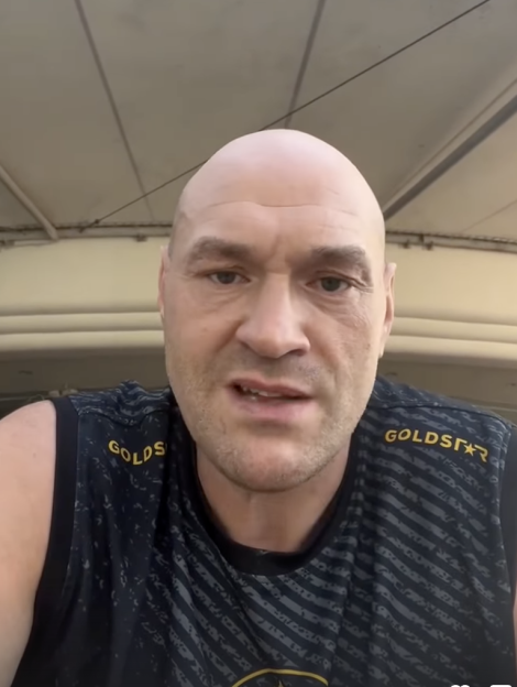 Tyson Fury in a black and gold "Goldstar" tank top.