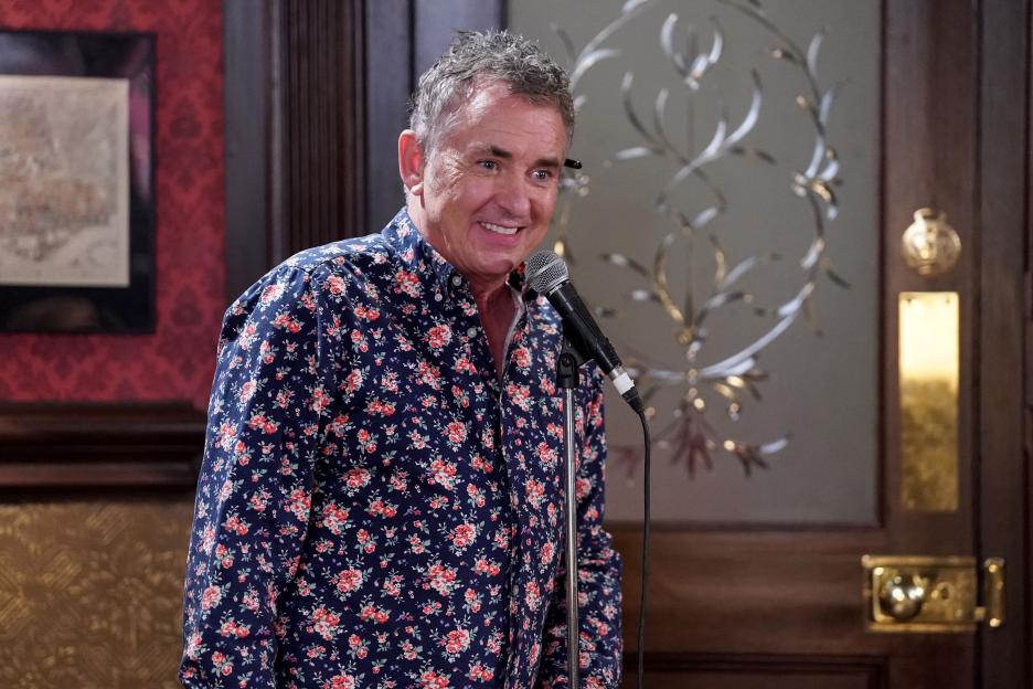 Jack Barns performing stand-up comedy on EastEnders.