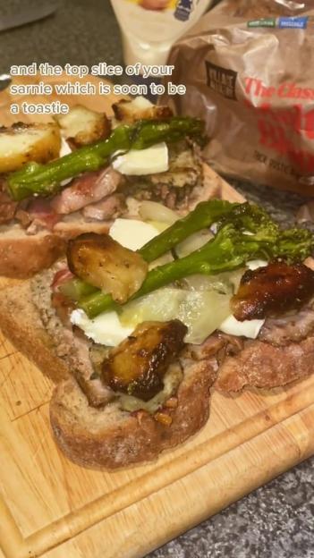 Christmas leftovers sandwich on a cutting board.