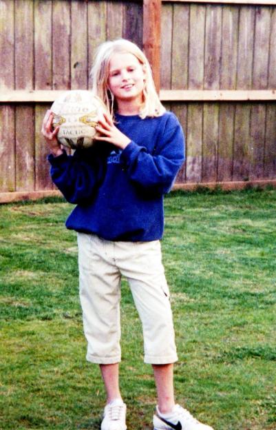 Holly Wells, aged 10, holds a soccer ball.