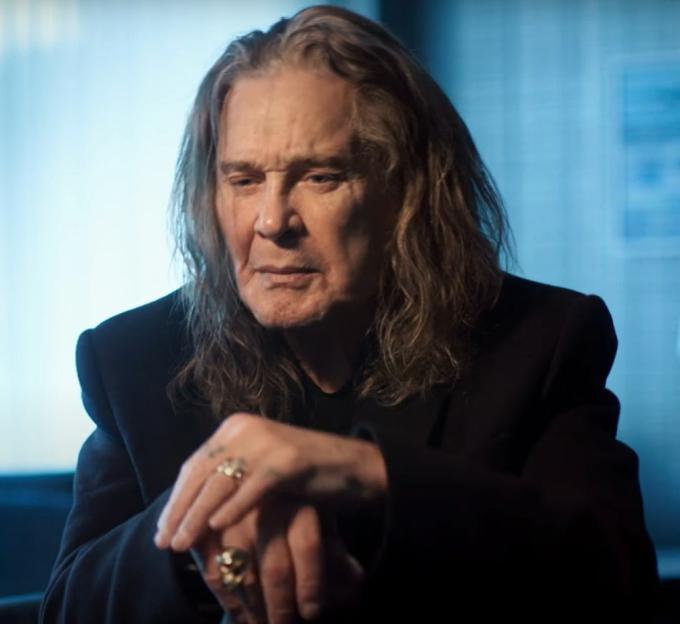 Ozzy Osbourne in a black suit.