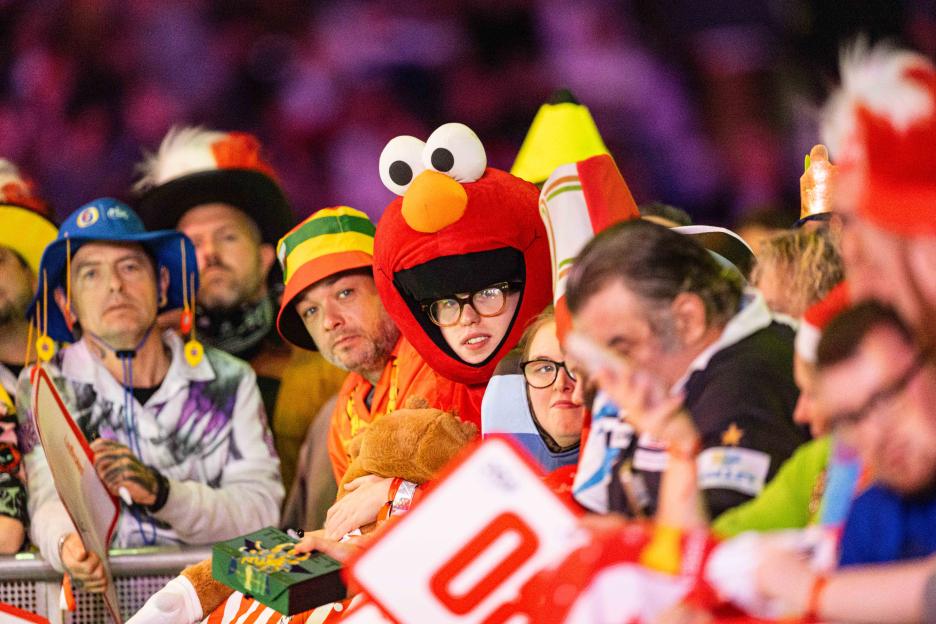 Fans in fancy dress waiting for players at a darts final.