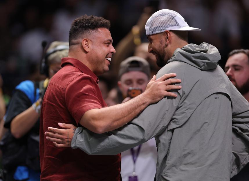 Nick Kyrgios hugs former footballer Ronaldo.