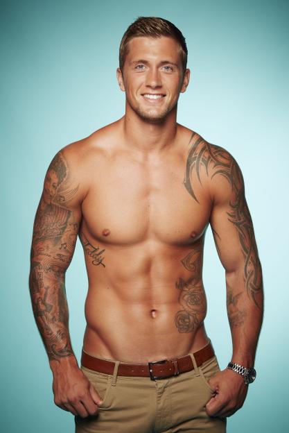 Dan Osbourne from "The Only Way Is Essex" TV Programme, smiling while shirtless, showing off his tattoos.