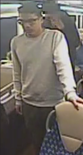 CCTV image of a man in a cream jumper and glasses.