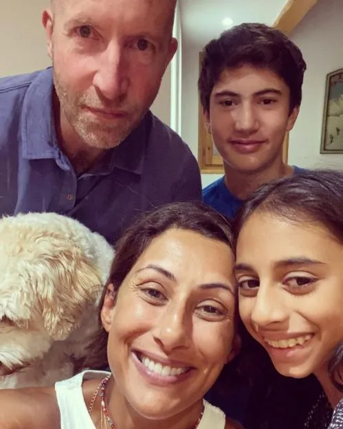 Saira Khan with her family, including her husband, son, daughter, and a family dog.