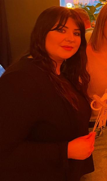 Naomi Hyland in a black top.