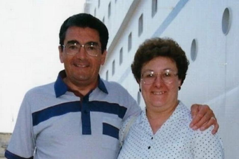 David and Susan smiling with a building in the background.