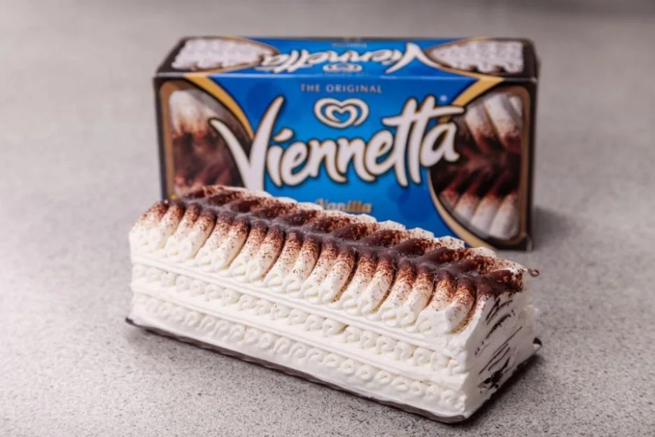 Close-up of a Viennetta ice cream cake with its blue box in the background.